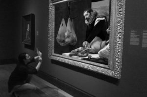 A visitor interacts with a painting